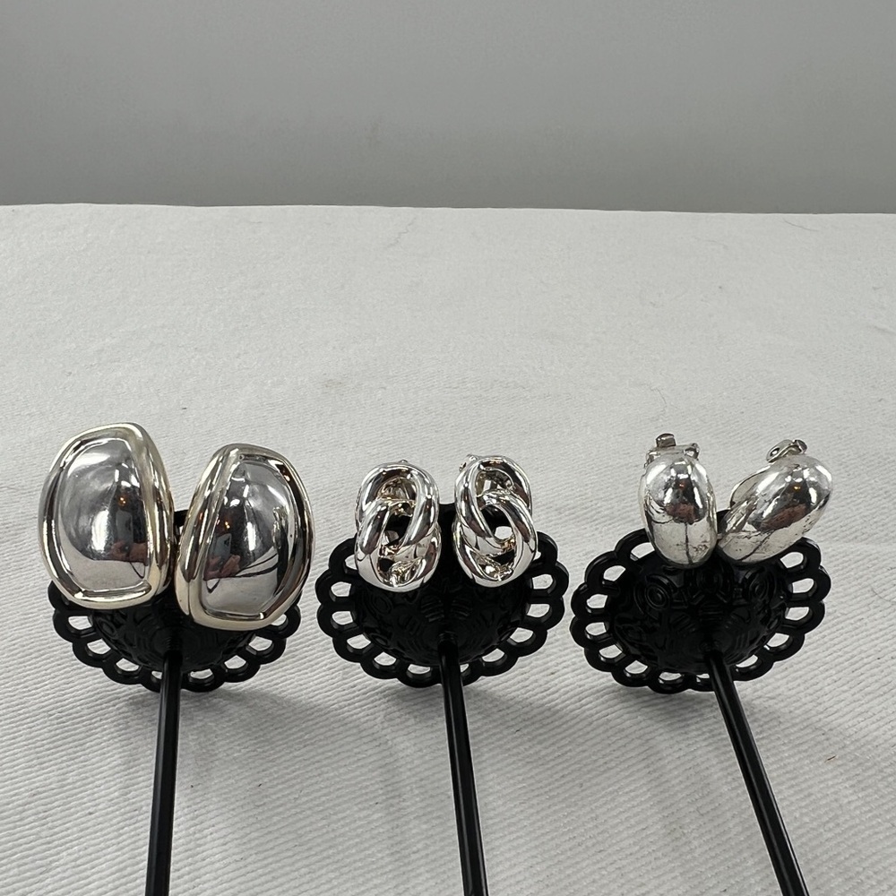 3 Pair of silver tone clip on earrings